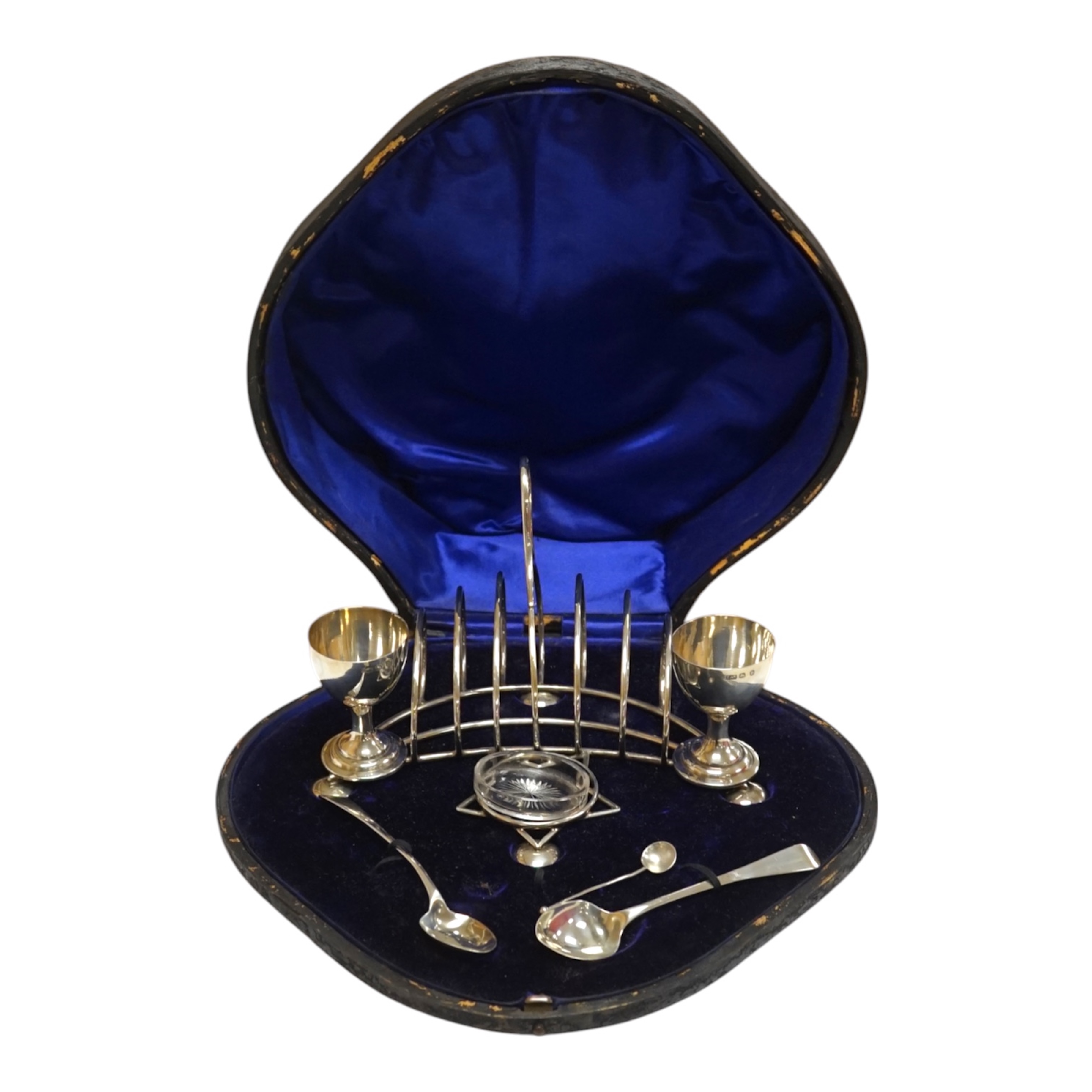 A cased George V silver egg and toast cruet, Levi & Salaman, Birmingham, 1895, width 19cm, with associated spoons. Condition - fair